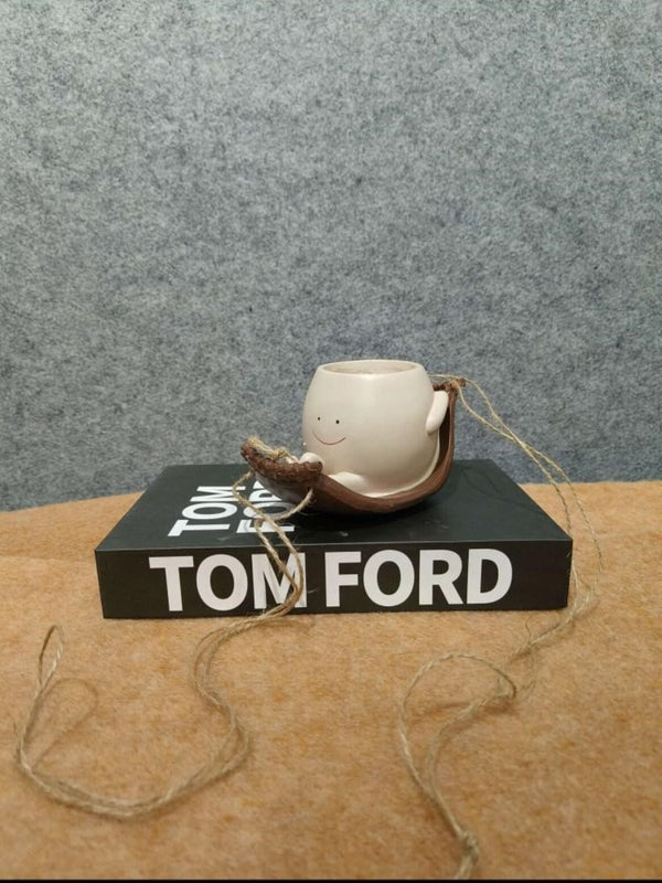 Artifacts Smiling Face Mini Planter/Cup in Rustic Hanging Holder on Decorative Book Base